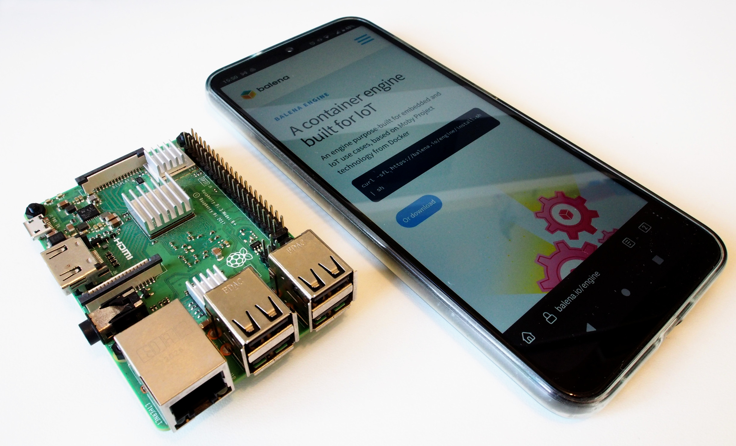 A Raspberry Pi 3 and a smart phone, side by side.